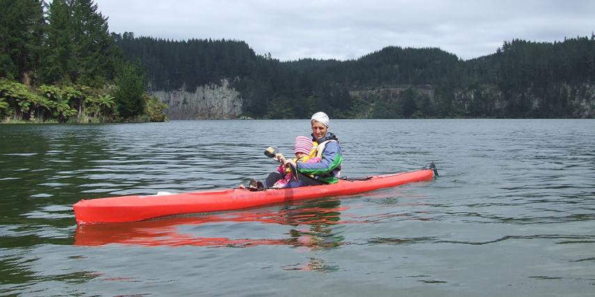 Parent and child kayaking on Lake Matahina