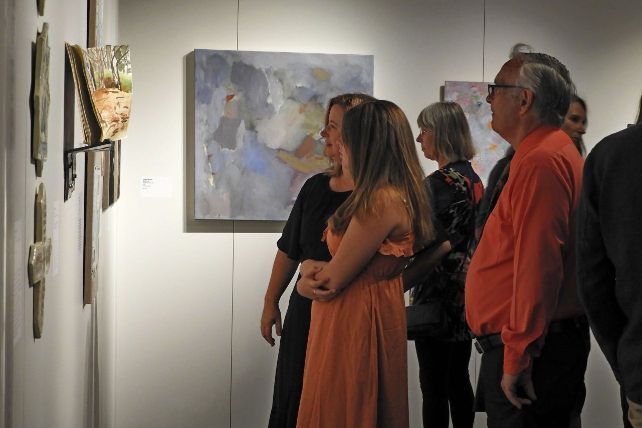 People enjoying artworks at the exhibition